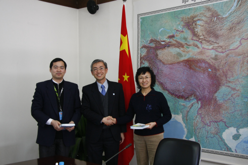 Mr. C.M. Shun (middle) presenting the book
