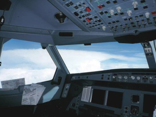 Capture of a huge thundery cloud in bright white colour through the windows of the cockpit. The top and the anvil of the thundery clouds could be clearly seen.