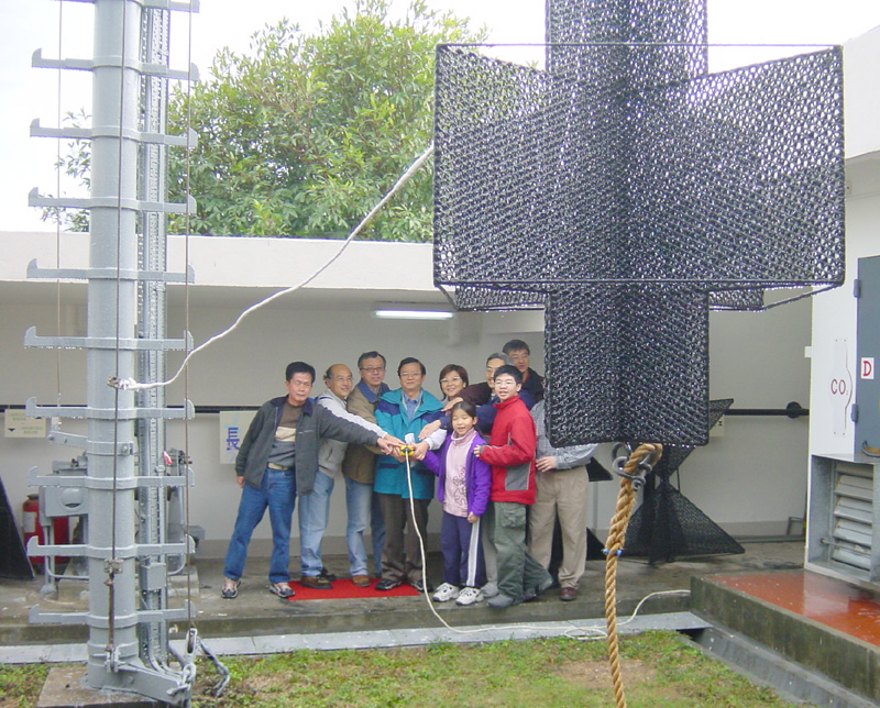The Director of the Hong Kong Observatory, Dr. H. K. Lam, officiating at the closing ceremony of Cheung Chau signal station by lowering the No. 10 signal.